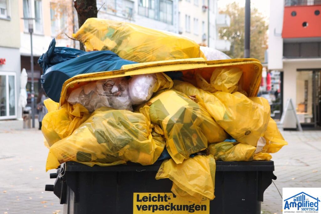 Container overflowing with plastic bags.