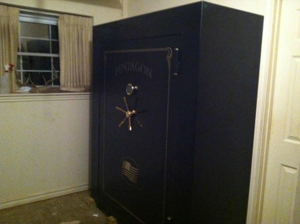 Large safe near a window in an old bedroom.