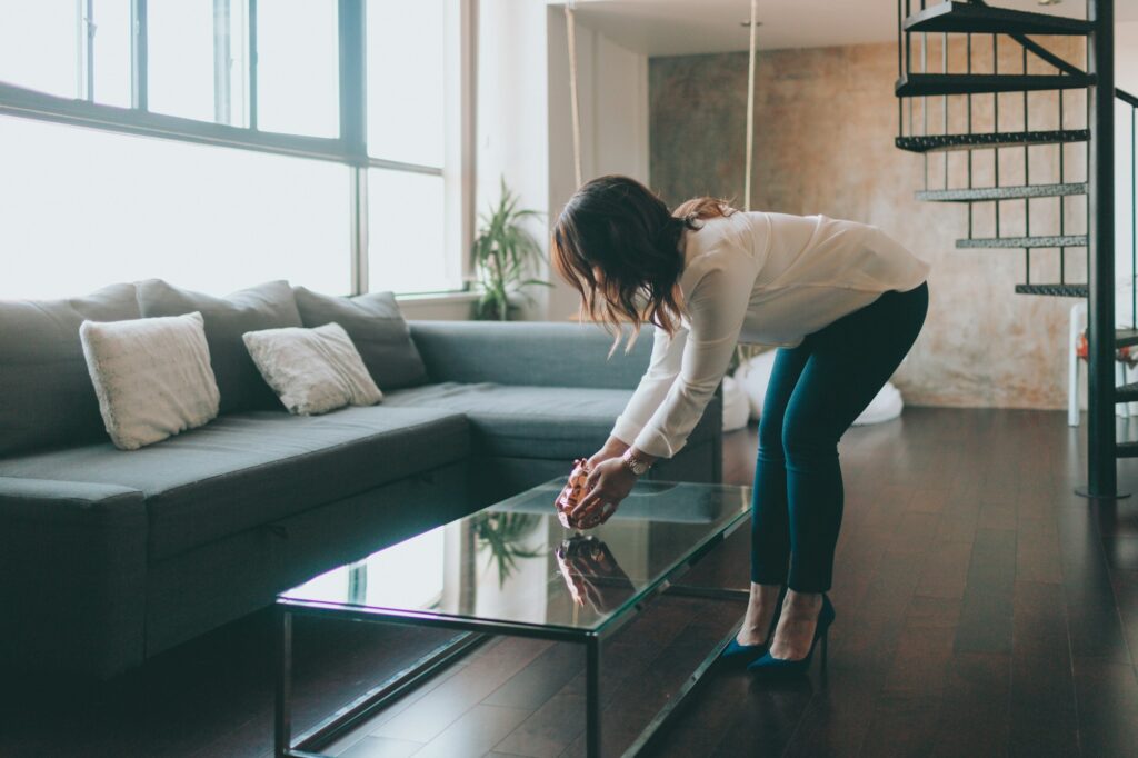 A woman staging a beautiful, modern apartment.