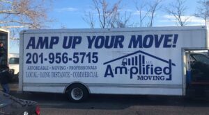 Moving truck with amplified moving logo parked by a street