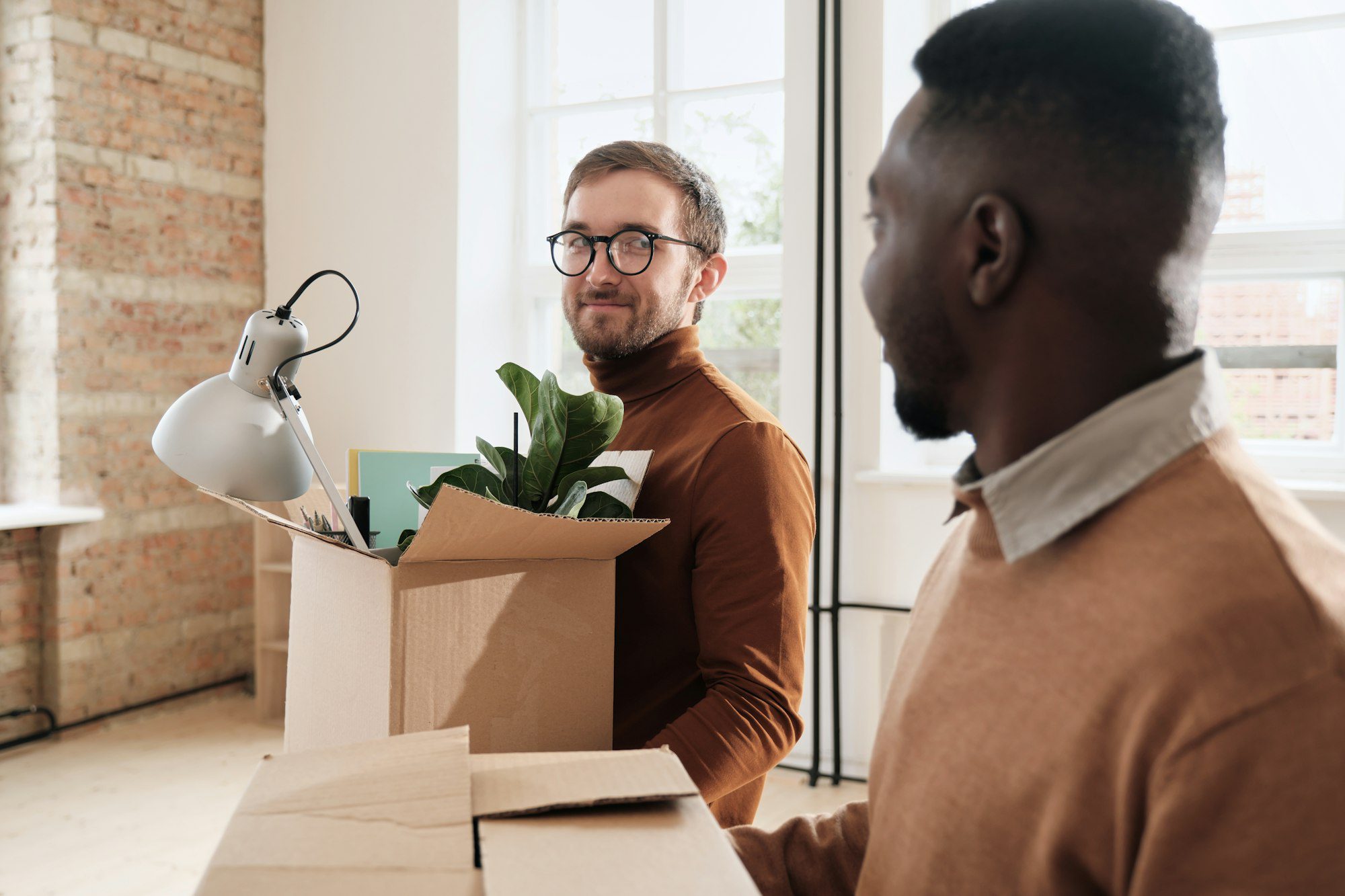 Young colleagues moving into loft office