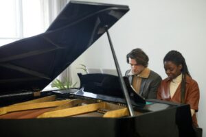 Young couple playing the piano together